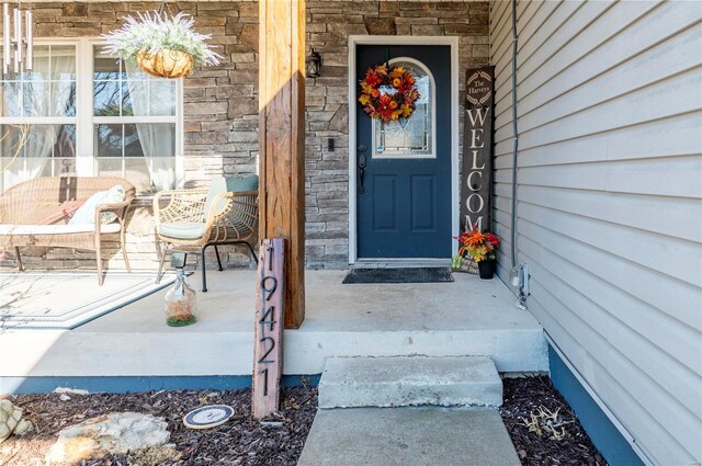 view of exterior entry featuring stone siding