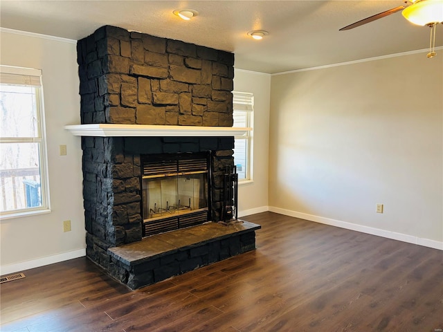 details featuring visible vents, ornamental molding, wood finished floors, a fireplace, and ceiling fan