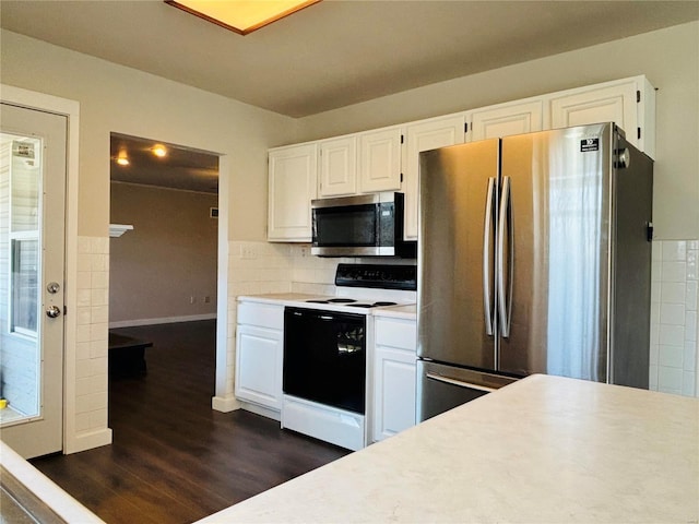 kitchen with appliances with stainless steel finishes, white cabinetry, light countertops, and dark wood-type flooring