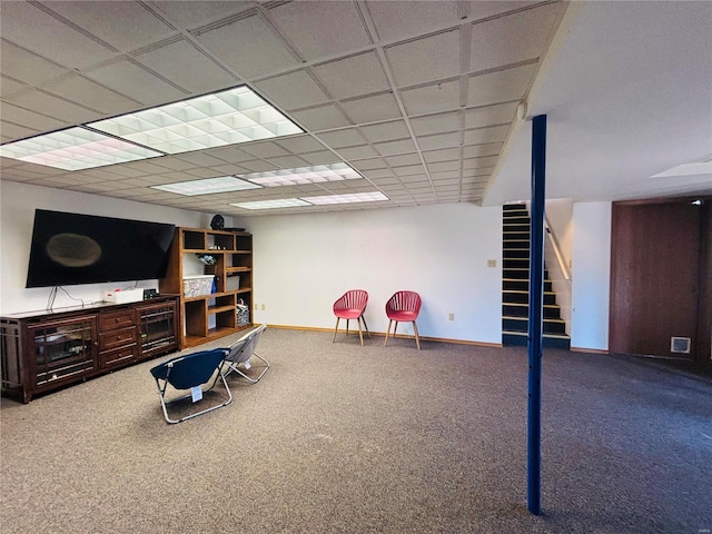 interior space featuring visible vents, baseboards, a drop ceiling, stairs, and carpet flooring