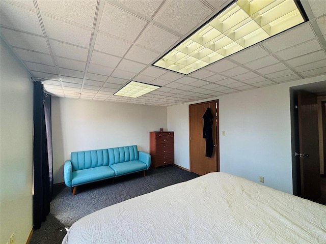 bedroom with a paneled ceiling and carpet