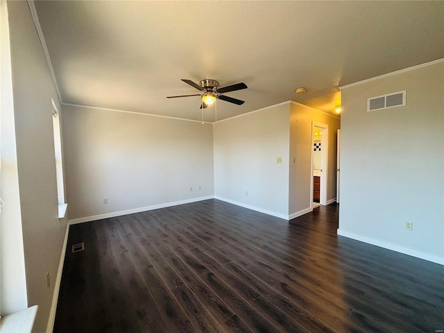 spare room with visible vents, ornamental molding, ceiling fan, and dark wood-style flooring