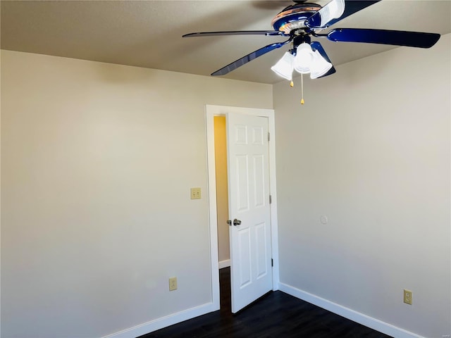 unfurnished room with dark wood-style floors, baseboards, and ceiling fan