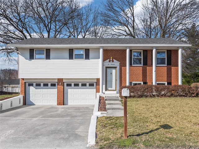 split foyer home featuring brick siding, an attached garage, concrete driveway, and a front lawn