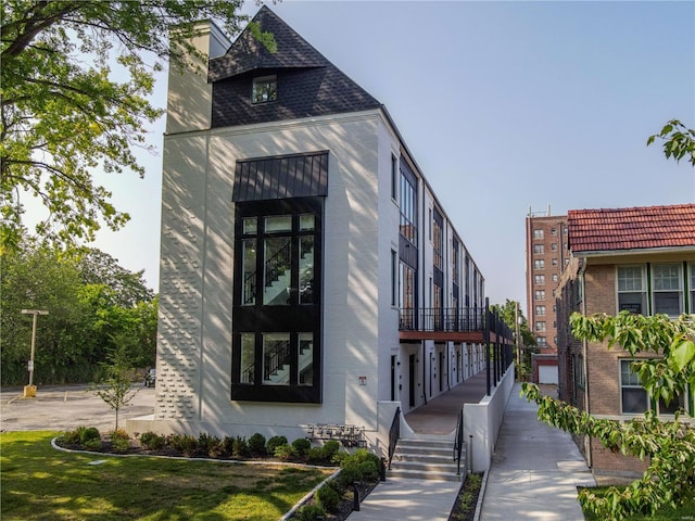 exterior space featuring brick siding and a chimney