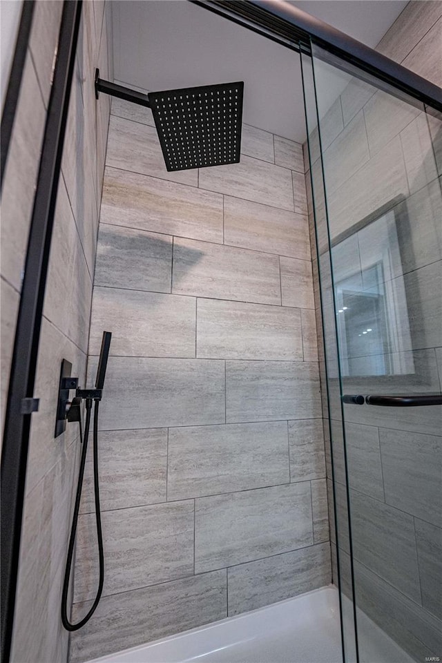 full bath with a tile shower