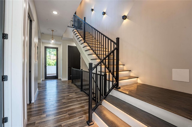 foyer featuring recessed lighting, stairs, baseboards, and wood finished floors