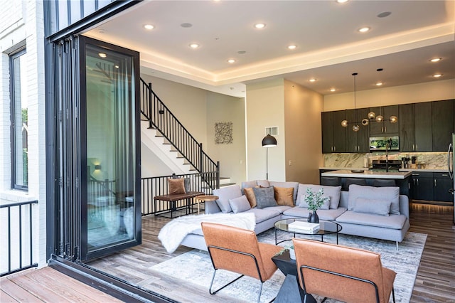 living area with stairway, recessed lighting, light wood-style floors, and visible vents