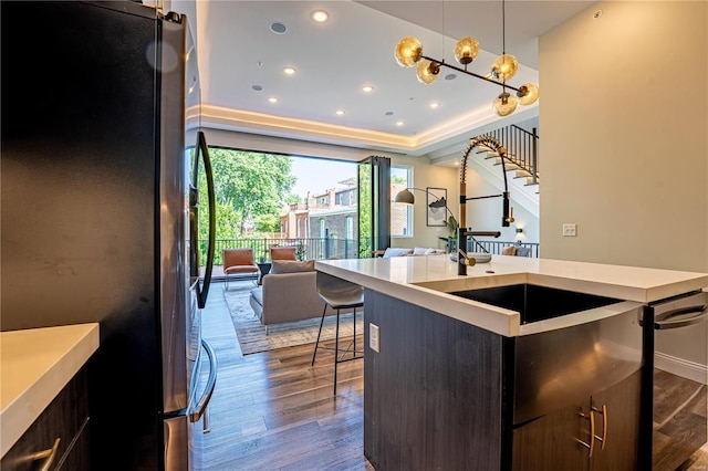 kitchen featuring dark wood finished floors, light countertops, open floor plan, and freestanding refrigerator