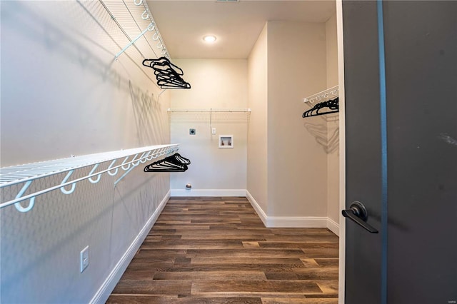 clothes washing area featuring hookup for a washing machine, dark wood-style floors, baseboards, laundry area, and electric dryer hookup