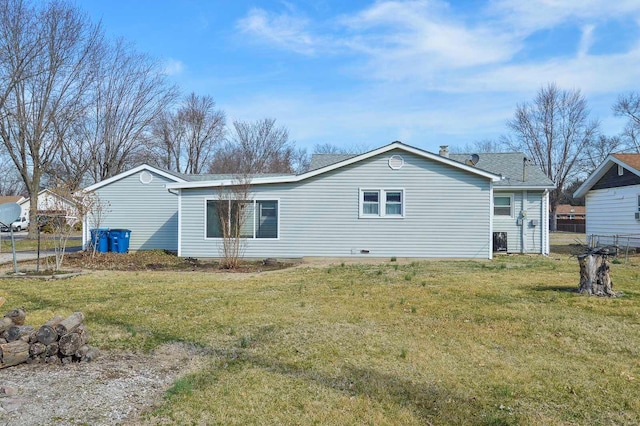 back of property featuring a yard and fence