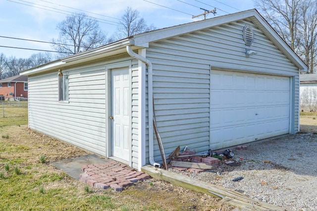 detached garage featuring fence