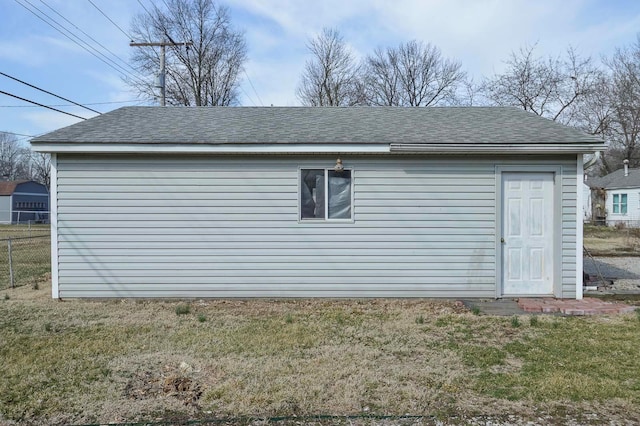 view of outdoor structure featuring an outbuilding and fence