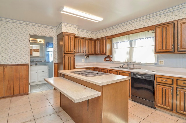 kitchen featuring wallpapered walls, a wainscoted wall, dishwasher, stainless steel electric cooktop, and a sink