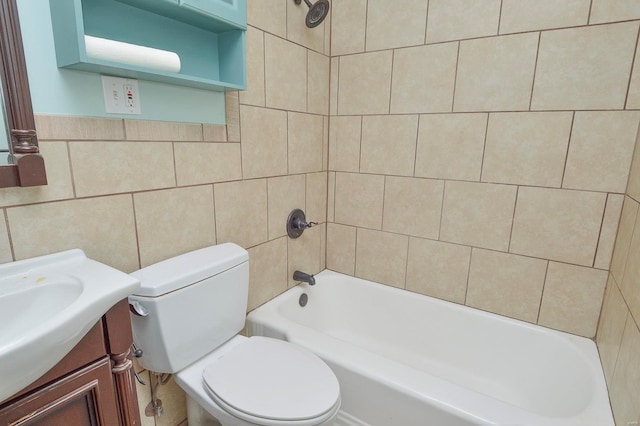 bathroom with washtub / shower combination, toilet, tile walls, and vanity