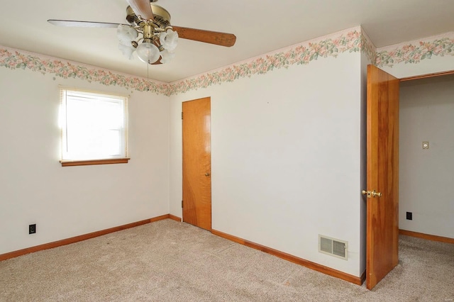 unfurnished room featuring baseboards, visible vents, carpet floors, and ceiling fan