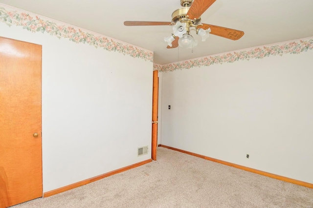 spare room featuring visible vents, baseboards, light colored carpet, and a ceiling fan