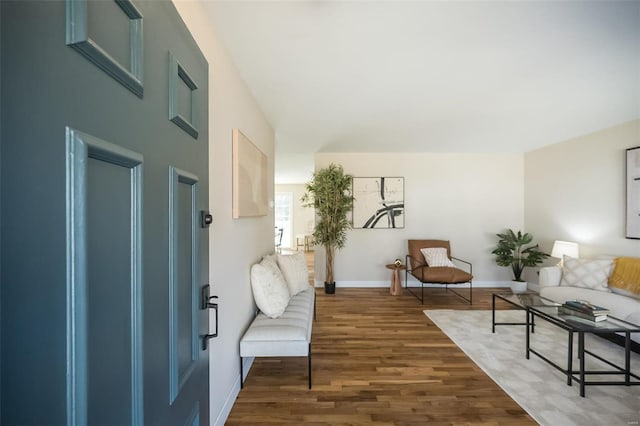 interior space featuring baseboards and dark wood-style flooring