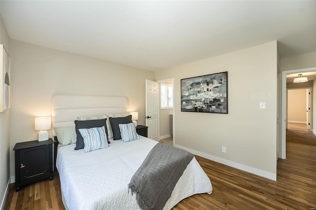 bedroom featuring wood finished floors and baseboards