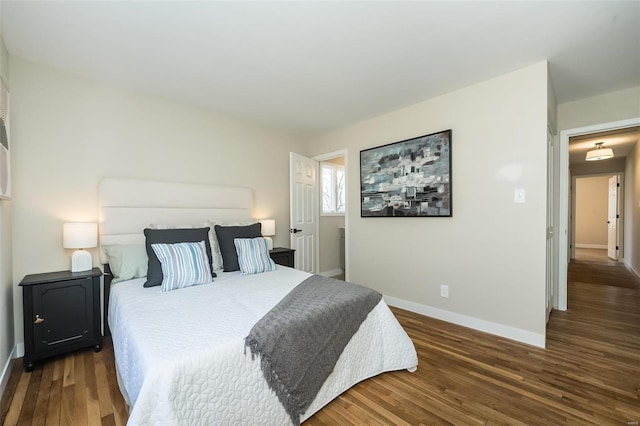 bedroom featuring baseboards and wood finished floors