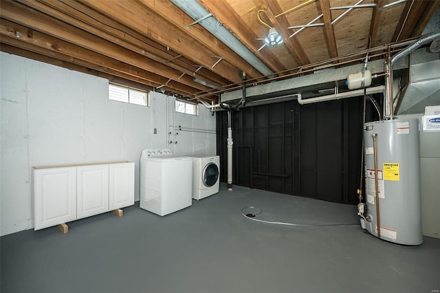 below grade area featuring washer and dryer and gas water heater