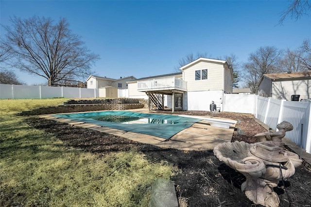 view of pool featuring a diving board, a fenced in pool, a fenced backyard, and stairway