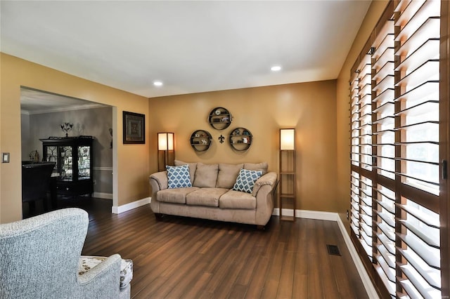 living area with dark wood-style floors, visible vents, recessed lighting, and baseboards