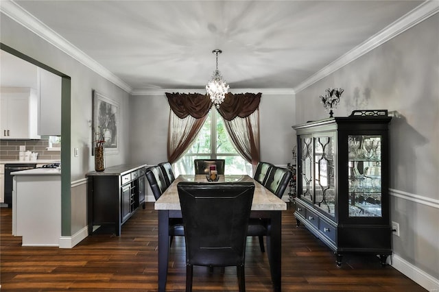 dining room with dark wood finished floors, a notable chandelier, and ornamental molding