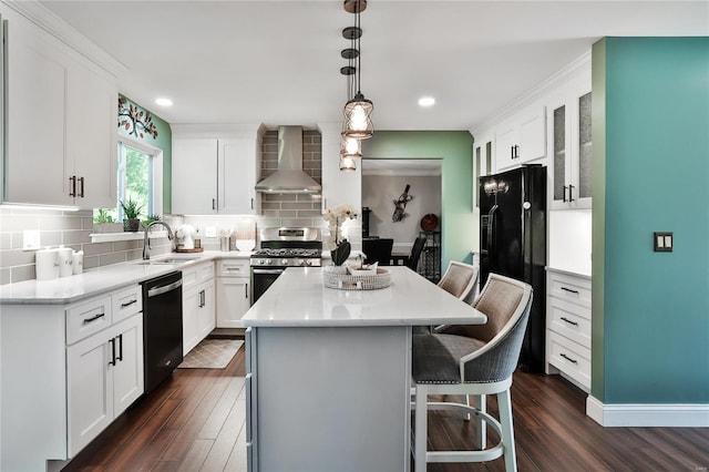 kitchen featuring a sink, black fridge with ice dispenser, wall chimney exhaust hood, dishwasher, and stainless steel range with gas stovetop