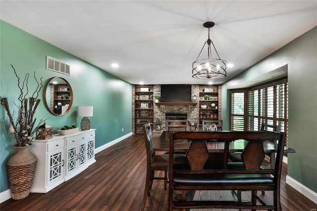 dining area featuring a fireplace, wood finished floors, visible vents, and baseboards