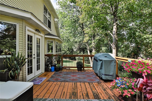 wooden terrace with french doors and area for grilling