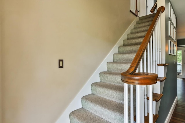 stairs with baseboards and wood finished floors