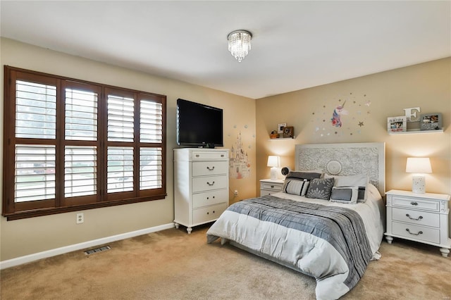 carpeted bedroom with visible vents and baseboards