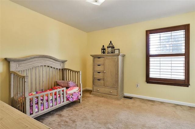 carpeted bedroom with visible vents and baseboards