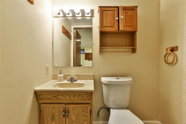 bathroom featuring toilet and vanity