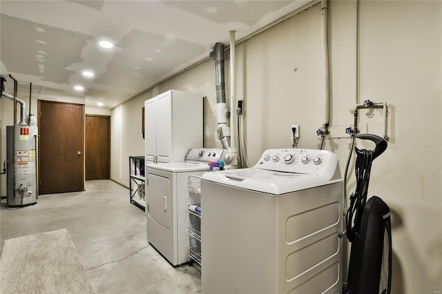 washroom featuring water heater and separate washer and dryer