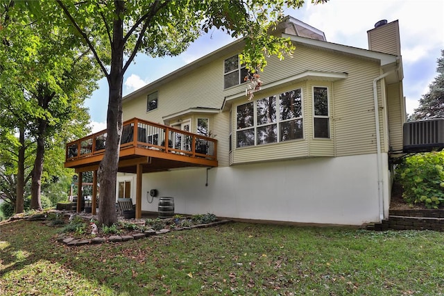 back of house with a yard, central air condition unit, a chimney, and a deck