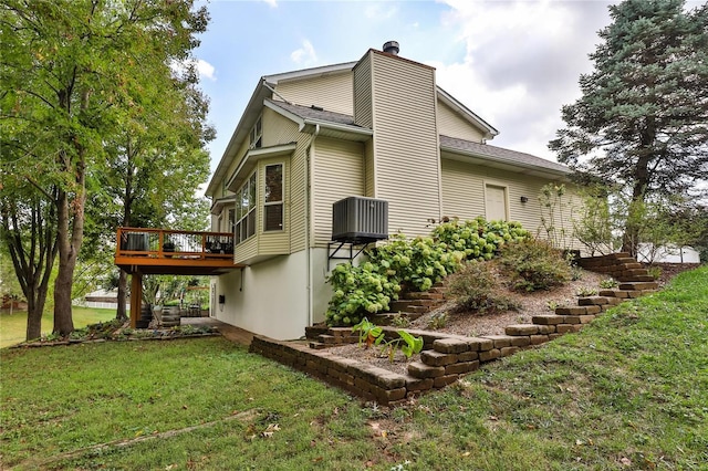 view of property exterior with a deck, stairway, a yard, and a chimney