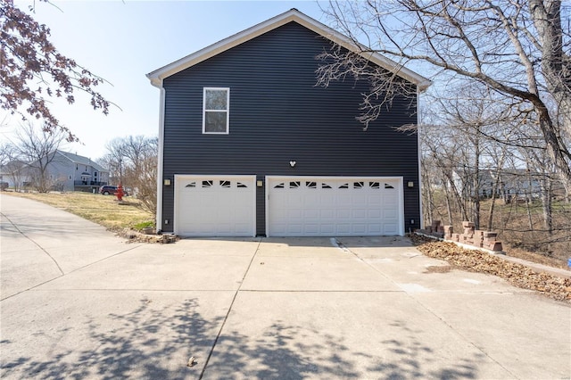 view of home's exterior with driveway and a garage