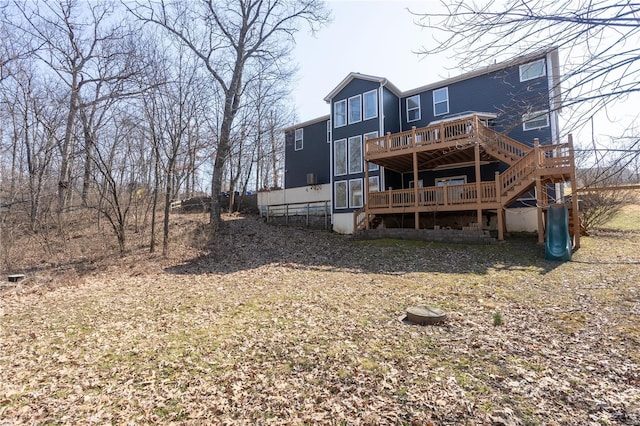 back of property with a wooden deck and stairway