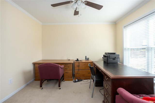 office space with baseboards, light colored carpet, ornamental molding, and a ceiling fan