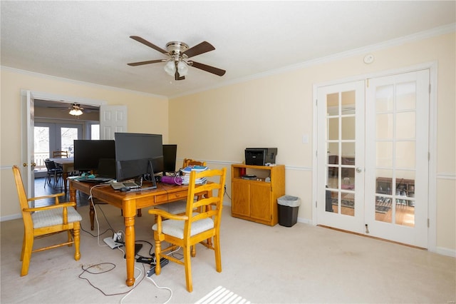 office space featuring light carpet, baseboards, ceiling fan, and ornamental molding