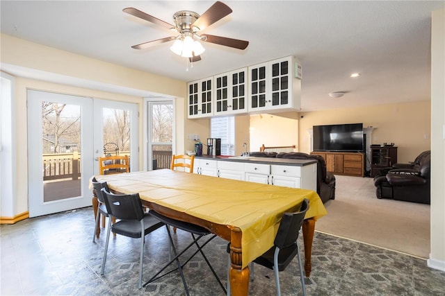 carpeted dining space with recessed lighting, a ceiling fan, a wealth of natural light, and a sink