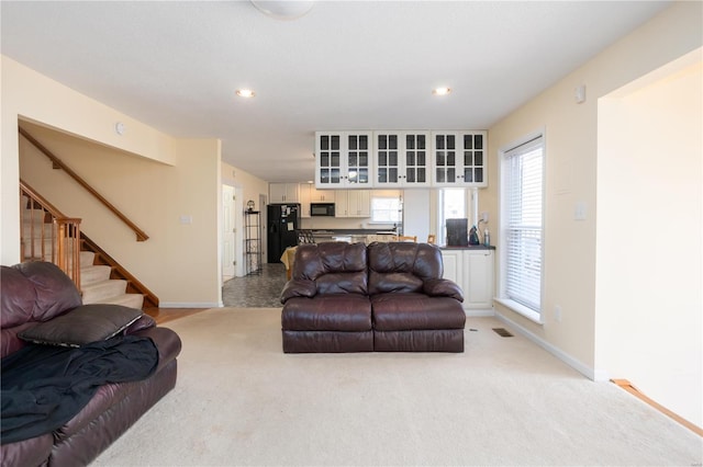 living area with stairway, recessed lighting, and baseboards