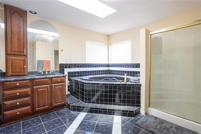 bathroom featuring a garden tub, a stall shower, vanity, and tile patterned flooring