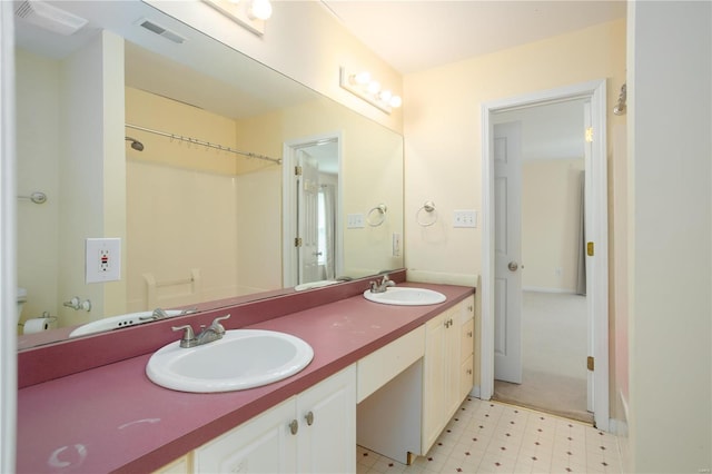 full bathroom with a sink, visible vents, double vanity, and tile patterned floors