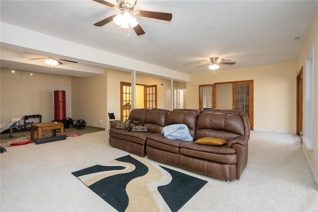 living area with a ceiling fan and carpet