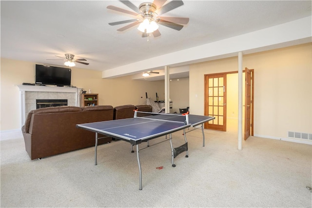 game room with a ceiling fan, visible vents, carpet floors, baseboards, and a fireplace