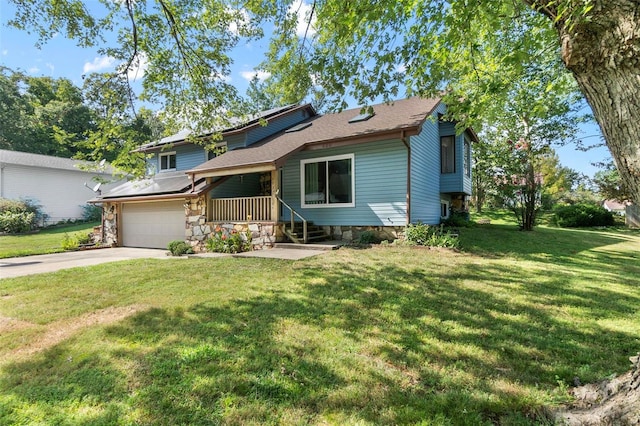 split level home featuring stone siding, driveway, a front yard, and a garage