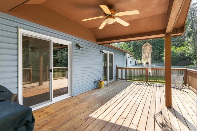 wooden terrace featuring ceiling fan and fence